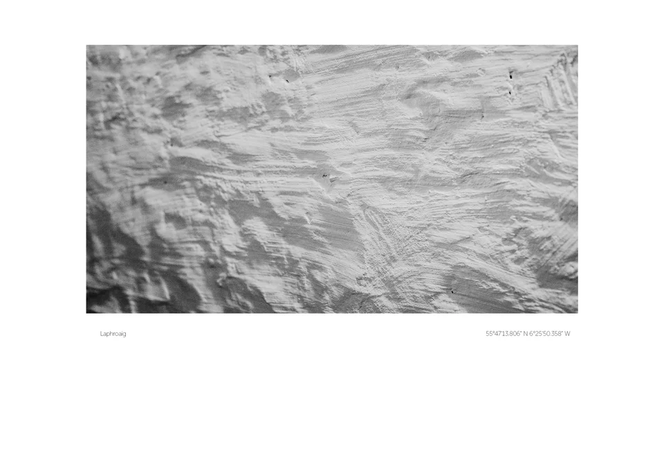 A close monochrome study of rippling textures and shadows, surrounded by a white print border.